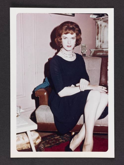 [Donna (Buff/Cynthia) in a navy dress in Susanna and Marie’s New York City apartment]

