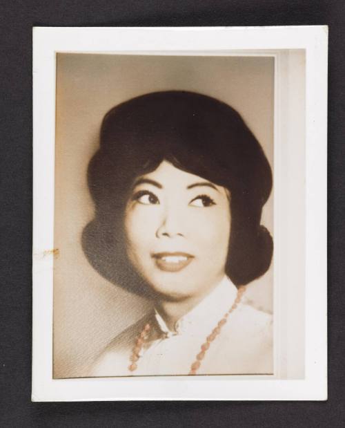 [Headshot of Lili, dark hair with coral necklace, location unknown]
