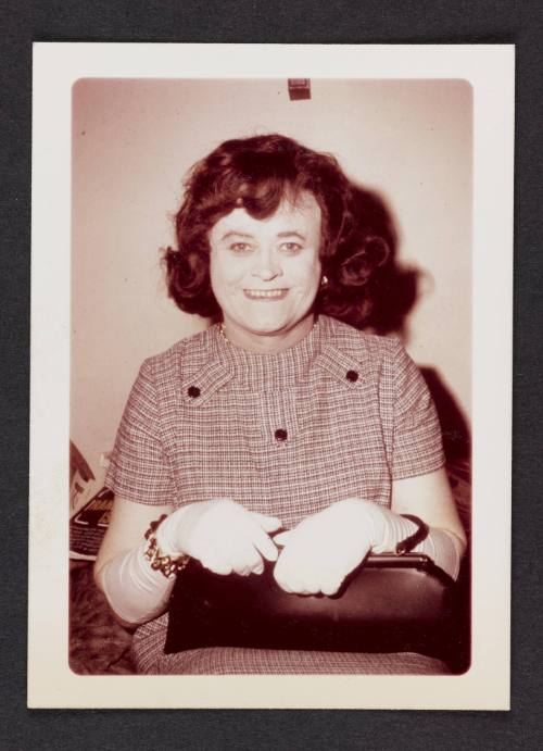 [Auburn hair and black clutch purse, location unknown]
