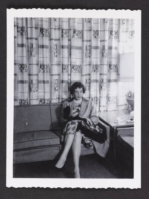 [Anita sitting on a couch in a hotel room, location unknown]
