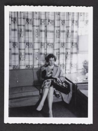[Anita sitting on a couch in a hotel room, location unknown]
