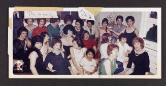 [Large group in the living room, location unknown]
