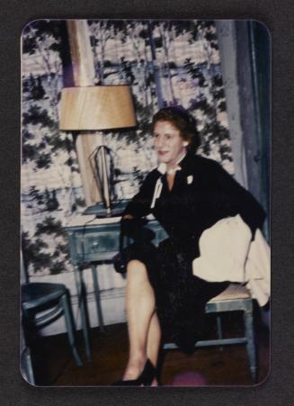 [Sitting in front of patterned curtains, location unknown]
