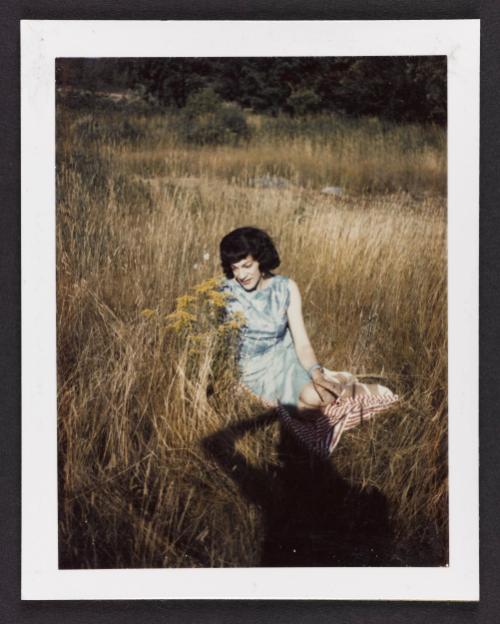 [Susanna sitting in the grass in a blue dress, Casa Susanna, Hunter, NY]
