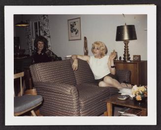 [Kathey with Susanna holding a cigarette on a couch, Casa Susanna, Hunter, NY]
