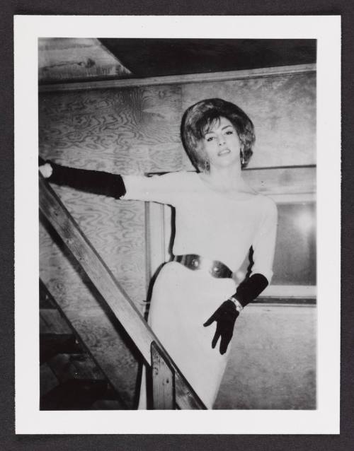 [White dress and black gloves, posing on the stairs, location unknown]
