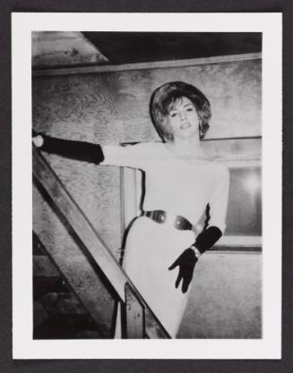 [White dress and black gloves, posing on the stairs, location unknown]
