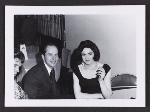 [Karen sitting with a man in a suit, location unknown]
