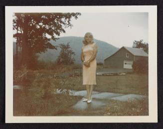 [Unnamed crossdresser in a peach dress and white shoes, Casa Susanna, Hunter, NY]
