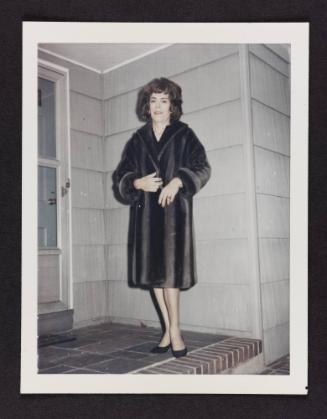 [Kathey on the steps in a fur coat, location unknown]

