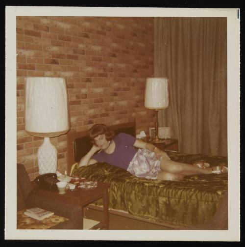 [Susanna in a purple shirt posing on the bed, location unknown]
