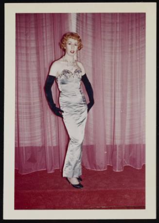 [Red head in a silver dress posing in front of curtains, Chevalier d'Eon, Hunter, NY]
