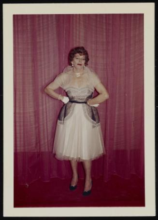 [Anita in a white and black chiffon dress in front of curtains, Chevalier d'Eon, Hunter, NY]
