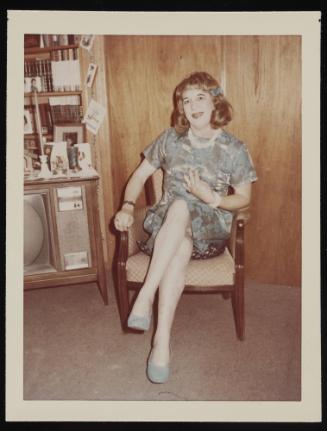 [In a blue dress, location unknown]
