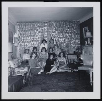 [Group portrait with Sheila, Donna (Buff/Cynthia), Wilma, Jody, Marilyn, Susanna and friends in Susanna and Marie’s New York City apartment]
