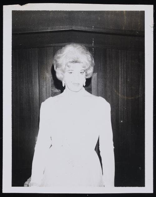 [Gloria in white outfit, location unknown]
