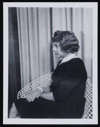 [Anita sitting in a white chair, location unknown]
