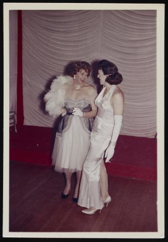 [Anita wearing a boa and standing with a friend on the stage at the Chevalier d’Éon, Halloween party, Hunter, NY]
