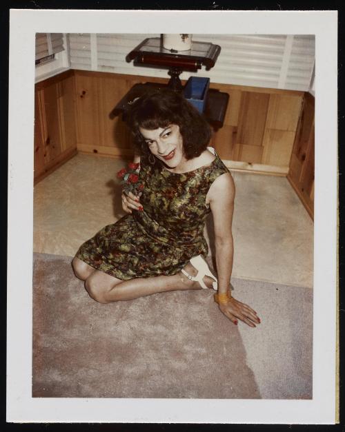 [Susanna sitting on the floor with flowers, location unknown]

