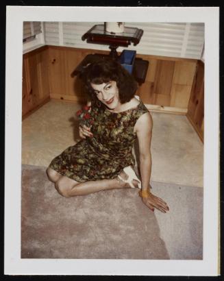 [Susanna sitting on the floor with flowers, location unknown]
