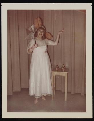 [Posing with an umbrella, location unknown]
