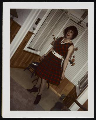 [Susanna in a plaid dress and white belt, location unknown]
