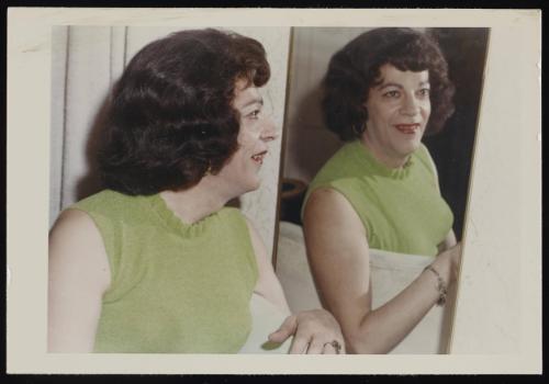 [Susanna in a green shirt posing beside a mirror, Casa Susanna, Hunter, NY]
