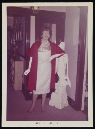 [Brunette posing beside a small statue, location unknown]
