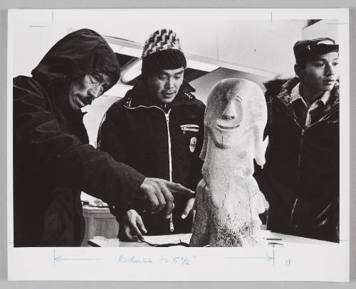 Igjookjuak selling carving, with James Eetoolook and David Totalik