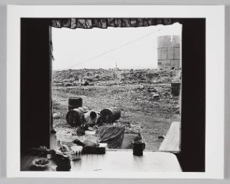 View of Karoo carving outside his matchbox house, seen from their window